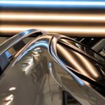 The roof railing on a silver vehicle with hail dents showing.