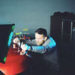 Expert auto technician skillfully performing Paintless Dent Repair (PDR) on a luxury vehicle under optimal lighting conditions in Denver, Colorado. Elevate your auto repair experience with precision and sophistication in the upscale neighborhoods of Cherry Hills Village, Greenwood Village, Lone Tree, and beyond.